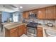 Well-designed kitchen with granite countertops, stainless steel appliances, and breakfast bar seating at 6408 Deadwood Rd, Las Vegas, NV 89108