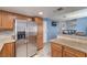 Bright kitchen featuring stainless steel refrigerator, granite counters, and adjacent living area at 6408 Deadwood Rd, Las Vegas, NV 89108