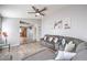 Inviting living room showcases a sectional couch, with views through to the breakfast nook and kitchen at 6408 Deadwood Rd, Las Vegas, NV 89108
