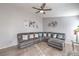 Spacious living room featuring a large sectional couch, modern decor, and bright, airy ambiance at 6408 Deadwood Rd, Las Vegas, NV 89108