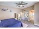 This is another view of the main bedroom featuring a ceiling fan, modern furniture, and wood floors at 6408 Deadwood Rd, Las Vegas, NV 89108
