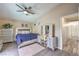 This is a view of the main bedroom featuring a ceiling fan, modern furniture, and wood floors at 6408 Deadwood Rd, Las Vegas, NV 89108