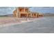 Under-construction home shows a two-story wood-framed structure with a fire hydrant nearby at 65 Bellissima Lago Ct, Henderson, NV 89011