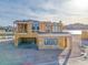 A modern home's framing showcases lake views and architectural elements at 65 Bellissima Lago Ct, Henderson, NV 89011
