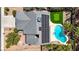 Aerial view showcases a well-maintained home with solar panels, a pool, putting green, and lush landscaping at 6773 Obannon Dr, Las Vegas, NV 89146