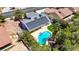 Aerial view showcases a well-maintained home with solar panels, a pool, putting green, and mature landscaping at 6773 Obannon Dr, Las Vegas, NV 89146
