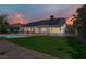 Spacious backyard with a putting green, solar panels, and a covered patio at 6773 Obannon Dr, Las Vegas, NV 89146