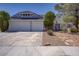 Two-story home featuring a two-car garage and desert landscaping at 6773 Obannon Dr, Las Vegas, NV 89146