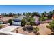 Aerial view of charming home featuring mature landscaping, a well-maintained lawn, and a spacious driveway at 6773 Obannon Dr, Las Vegas, NV 89146