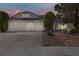 Charming single-story home with a two-car garage, desert landscaping, and a tiled roof at 6773 Obannon Dr, Las Vegas, NV 89146