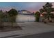 View of a single story home with a 2-car garage and desert landscaping at 6773 Obannon Dr, Las Vegas, NV 89146