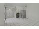 Spacious kitchen featuring white tile flooring and stainless refrigerator at 6773 Obannon Dr, Las Vegas, NV 89146