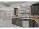 This kitchen has black cabinets, stainless steel appliances, granite countertops and a view of the pool at 6773 Obannon Dr, Las Vegas, NV 89146