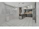 The updated kitchen offers black cabinets, stainless appliances, granite countertops and recessed lighting at 6773 Obannon Dr, Las Vegas, NV 89146