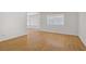 Bright living room with wood floors and multiple windows with blinds, showcasing open space at 6773 Obannon Dr, Las Vegas, NV 89146