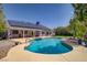 Inviting backyard pool with lush landscaping, spa and home with solar panels offering a serene oasis at 6773 Obannon Dr, Las Vegas, NV 89146