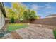Landscaped backyard with a lovely patio, mature trees, and low-maintenance design at 7052 Blissful Peak St, North Las Vegas, NV 89084