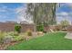 The backyard features artificial turf, rock landscaping, and a brick perimeter wall at 7052 Blissful Peak St, North Las Vegas, NV 89084