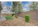 Beautiful backyard featuring low maintenance landscaping, a small turf area, and block wall fencing at 7052 Blissful Peak St, North Las Vegas, NV 89084