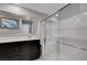 Bright bathroom with modern vanity, framed mirror, and glass-enclosed shower at 7052 Blissful Peak St, North Las Vegas, NV 89084
