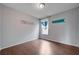 Bright bedroom with laminate flooring, painted accents, and a window at 7052 Blissful Peak St, North Las Vegas, NV 89084