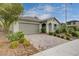 Inviting one-story home with a tile roof, two-car garage, and charming desert landscaping at 7052 Blissful Peak St, North Las Vegas, NV 89084