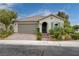 Charming single-story home featuring a two-car garage, tile roof, and beautifully landscaped front yard at 7052 Blissful Peak St, North Las Vegas, NV 89084