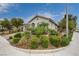 Landscaped front yard with lush greenery and a well-maintained lawn enhances the curb appeal of this charming single-story home at 7052 Blissful Peak St, North Las Vegas, NV 89084