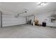 Spacious two car garage with white painted walls and plenty of room for storage and parking at 7052 Blissful Peak St, North Las Vegas, NV 89084