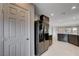 Open kitchen with dark cabinets, granite countertops and stainless steel refrigerator at 7052 Blissful Peak St, North Las Vegas, NV 89084
