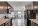 Modern kitchen with dark cabinetry, granite countertops, and stainless steel appliances is ready for culinary adventures at 7052 Blissful Peak St, North Las Vegas, NV 89084