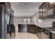 Spacious open kitchen with dark cabinets, granite countertops and stainless steel appliances at 7052 Blissful Peak St, North Las Vegas, NV 89084