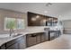 Modern kitchen featuring granite counters, stainless steel appliances, and dark wood cabinetry at 7052 Blissful Peak St, North Las Vegas, NV 89084