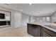 Bright kitchen island featuring granite countertops and dark wood cabinets at 7052 Blissful Peak St, North Las Vegas, NV 89084