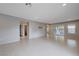 Expansive living space offering neutral tones, tiled floors, and sliding glass doors that provide ample natural light at 7052 Blissful Peak St, North Las Vegas, NV 89084