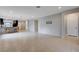 Open floor plan seamlessly connects the living area to the kitchen, with smooth, tiled floors and recessed lighting at 7052 Blissful Peak St, North Las Vegas, NV 89084