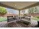 Relaxing covered patio with comfortable seating, offering a serene outdoor living space at 7052 Blissful Peak St, North Las Vegas, NV 89084