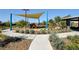 Community playground featuring shade structures, play equipment, and landscaping at 7052 Blissful Peak St, North Las Vegas, NV 89084