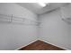 Spacious walk-in closet with laminate flooring and built-in shelving at 7052 Blissful Peak St, North Las Vegas, NV 89084