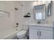 Modern bathroom featuring a shower-over-tub, white cabinets, and stylish fixtures at 718 Nectarine Ct, Henderson, NV 89014