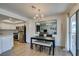 Dining area with modern chandelier, stainless appliances, and a large mirror accent at 718 Nectarine Ct, Henderson, NV 89014