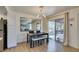 Well-lit dining space features modern furnishings, an accent mirror, and patio access at 718 Nectarine Ct, Henderson, NV 89014