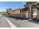 Exterior view of townhouse featuring attached garages and a private staircase to the above unit at 718 Nectarine Ct, Henderson, NV 89014