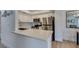 Bright kitchen features stainless steel appliances, white cabinetry, and a stylish backsplash at 718 Nectarine Ct, Henderson, NV 89014