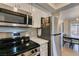 Well-equipped kitchen features stainless steel appliances, tile backsplash, and adjacent dining area at 718 Nectarine Ct, Henderson, NV 89014