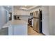 Updated kitchen with stainless steel appliances, quartz countertops and white cabinets at 718 Nectarine Ct, Henderson, NV 89014