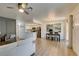 Stylish living room with gray accent wall, modern lighting, and open kitchen view at 718 Nectarine Ct, Henderson, NV 89014