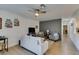 Inviting living room featuring neutral tones, comfortable seating, and a modern ceiling fan at 718 Nectarine Ct, Henderson, NV 89014