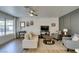 Well-lit living room boasts neutral color palette, stylish furnishings, and a ceiling fan at 718 Nectarine Ct, Henderson, NV 89014