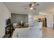Comfortable living room with modern decor, open kitchen access, and ceiling fan at 718 Nectarine Ct, Henderson, NV 89014